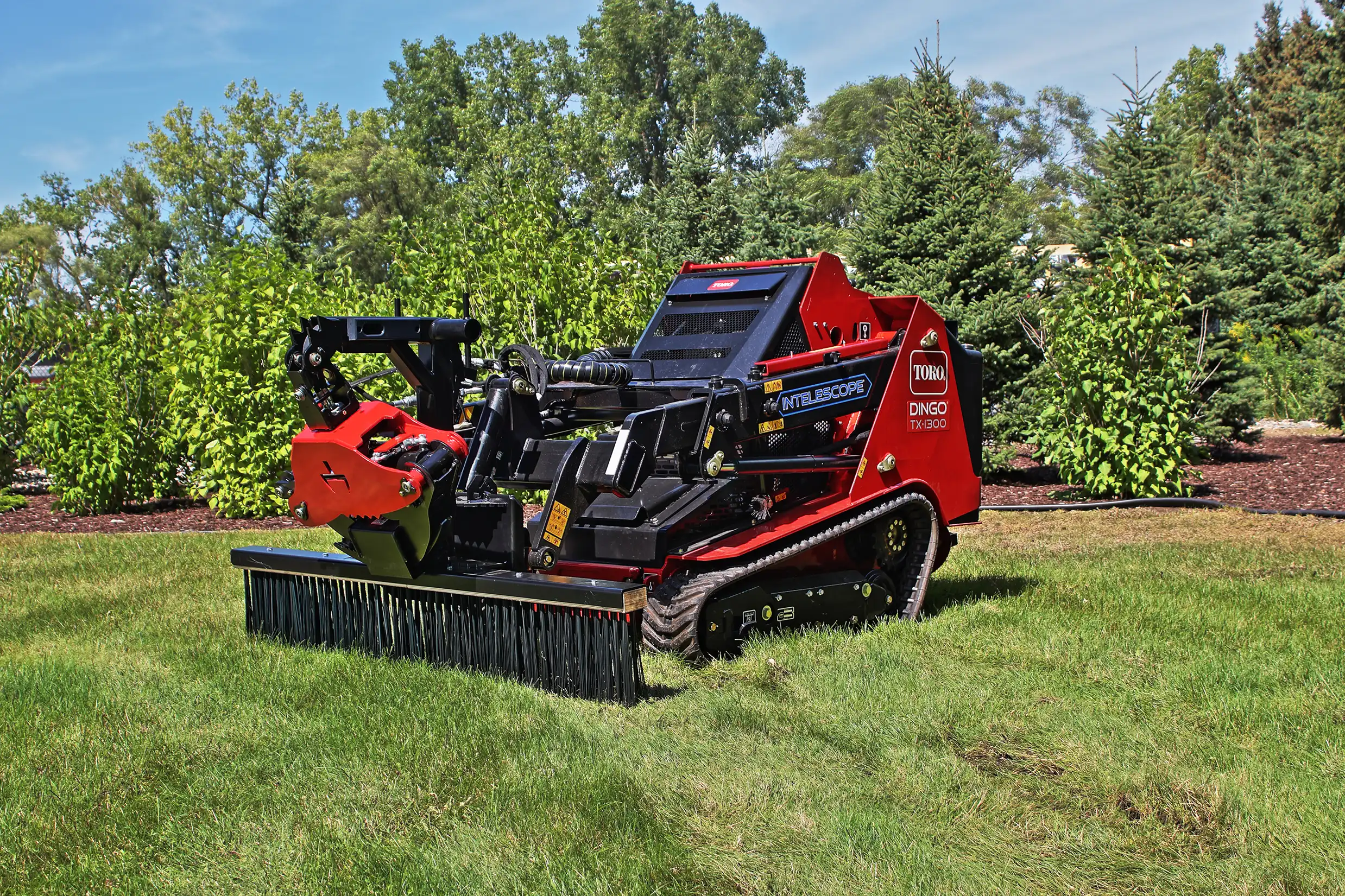 T3005 Grapple with the T1070 BMG Rake on a Toro Dingo TX-1300